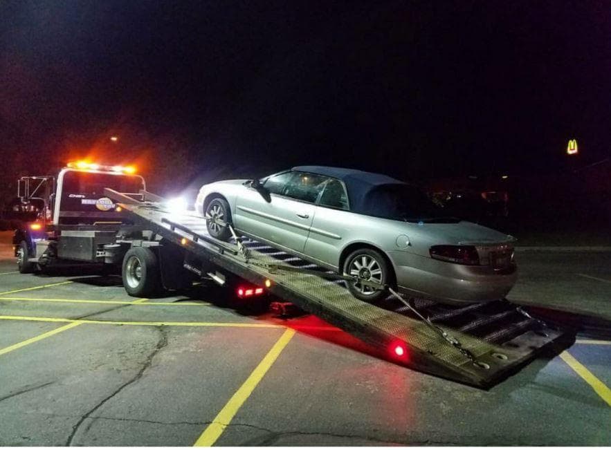 Vehicle on flatbed tow truck